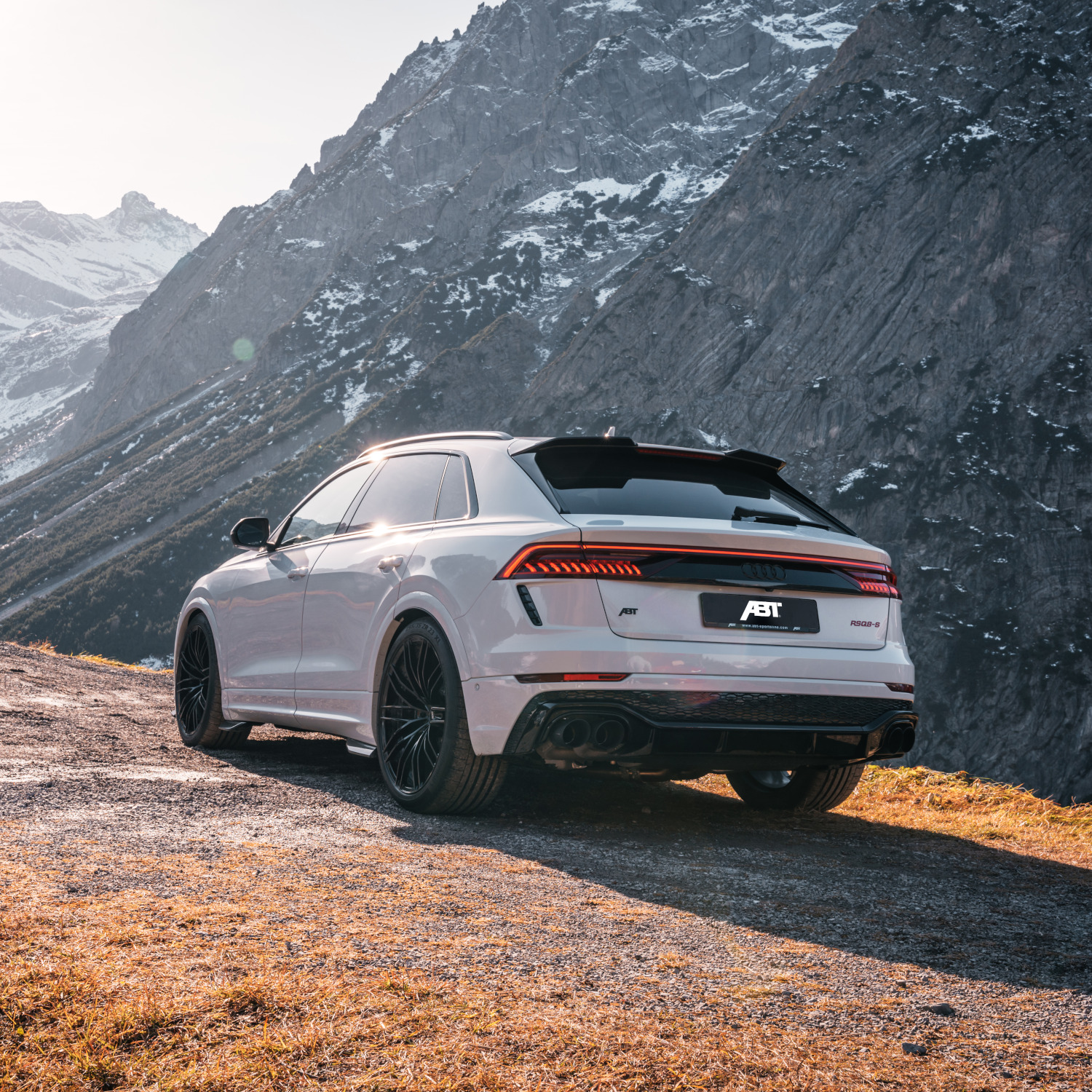 White RSQ8-S from the rear view in front of a mountain